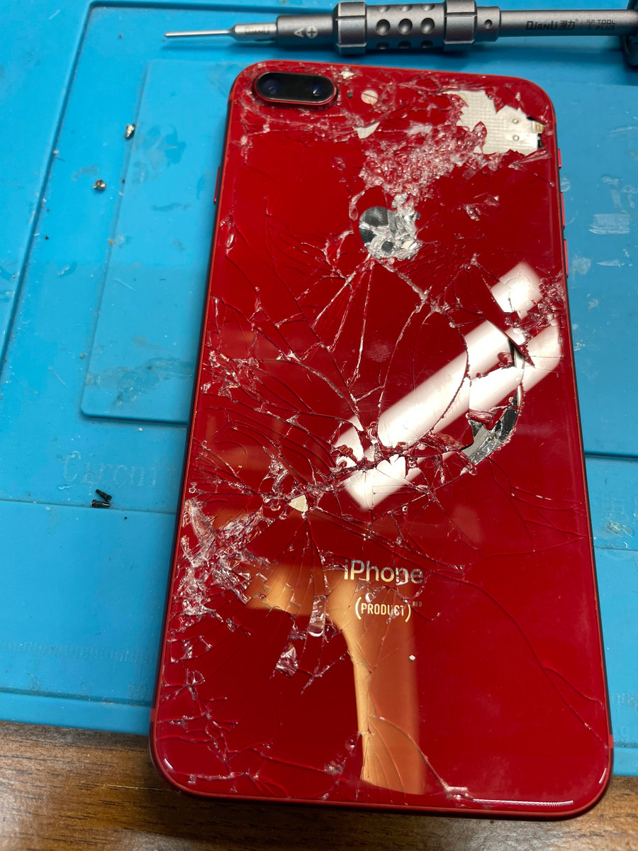 Broken red iPhone back glass before repair
